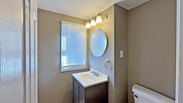 bathroom featuring vanity and toilet