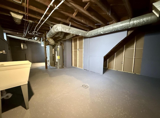 basement featuring sink and water heater