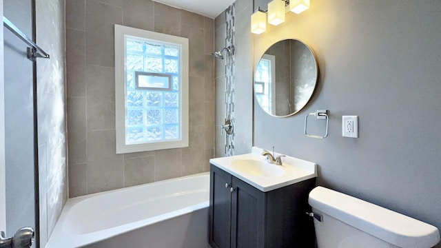 full bathroom with vanity, toilet, and tiled shower / bath