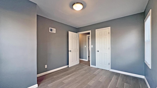 unfurnished bedroom featuring hardwood / wood-style floors