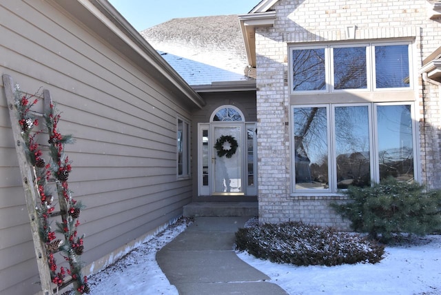 view of snow covered property entrance