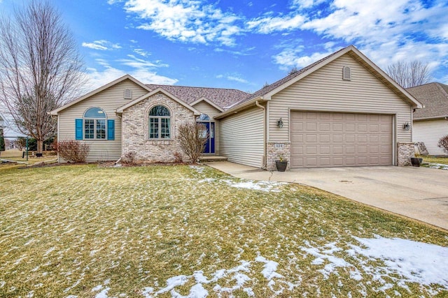 ranch-style house featuring a yard and a garage