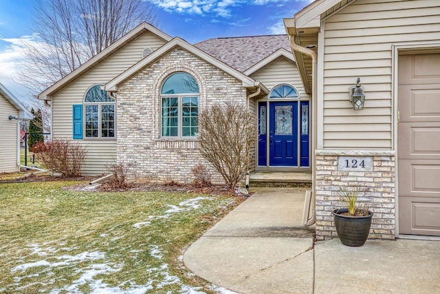 entrance to property featuring a yard