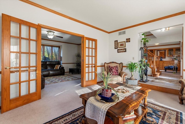 living room with carpet, french doors, ceiling fan, and ornamental molding