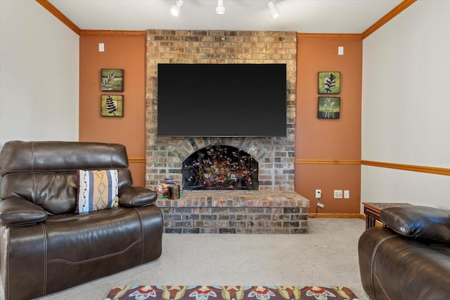 carpeted living room featuring ornamental molding, rail lighting, and a brick fireplace