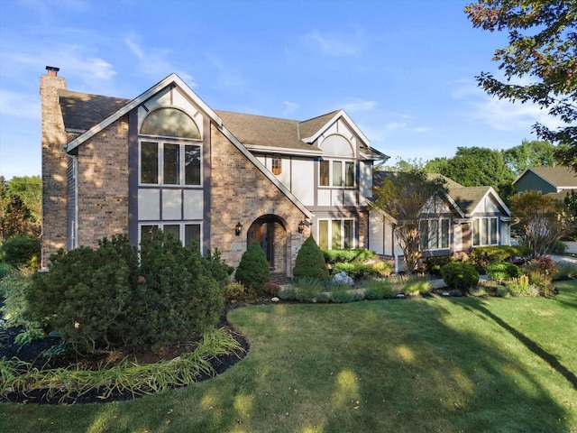 tudor home with a front yard