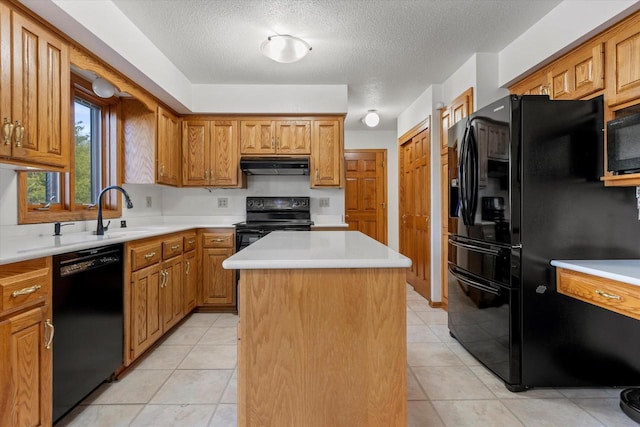 kitchen with sink, a textured ceiling, a center island, and black appliances