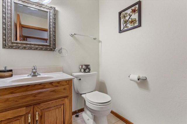 bathroom featuring tile patterned flooring, vanity, and toilet