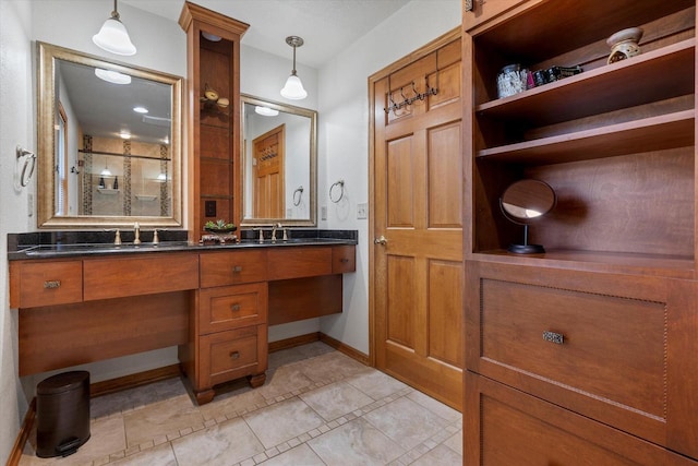 bathroom with tile patterned floors, vanity, and a shower with door