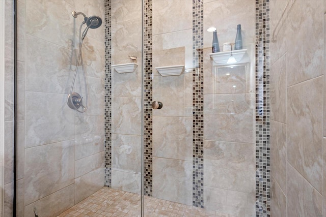 interior details featuring a tile shower