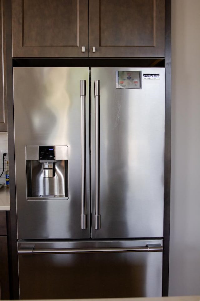 interior details with dark brown cabinetry and stainless steel fridge with ice dispenser