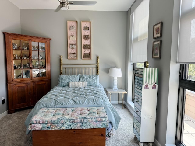 bedroom featuring ceiling fan and carpet