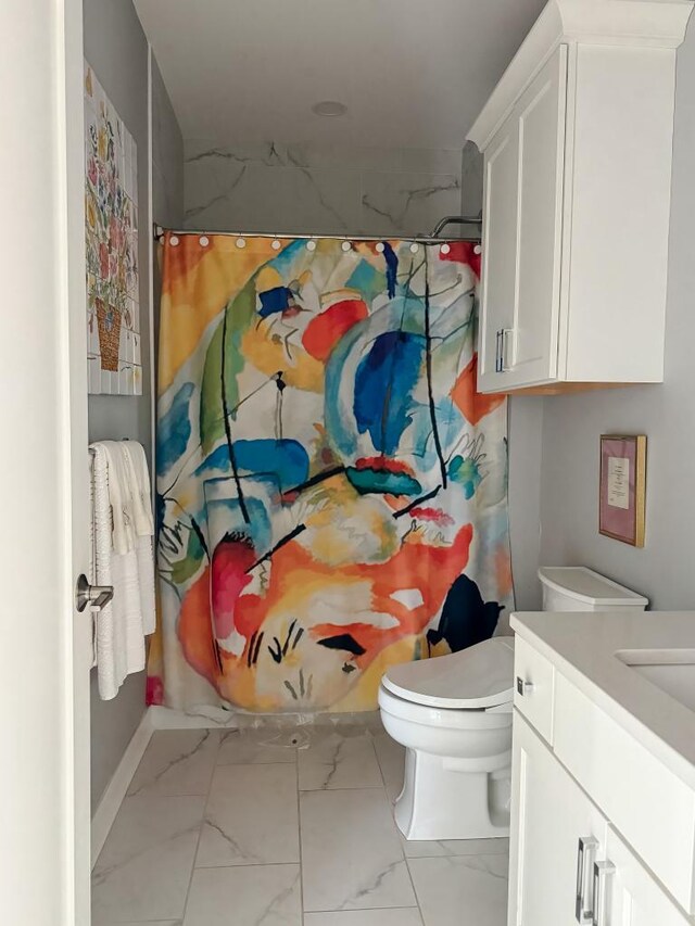 bathroom with toilet, vanity, and walk in shower