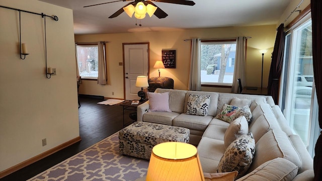 living room with ceiling fan and dark hardwood / wood-style flooring