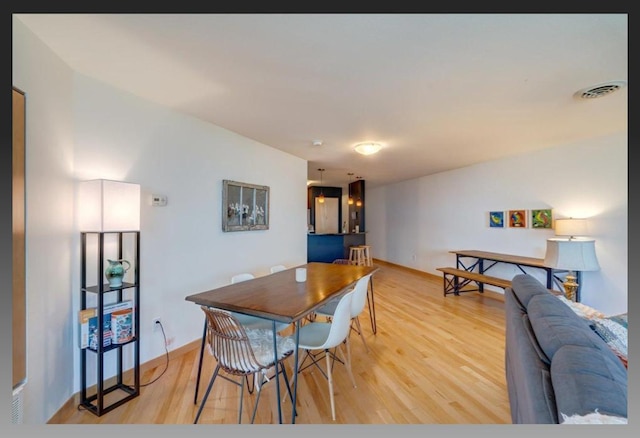 dining area with light wood-type flooring