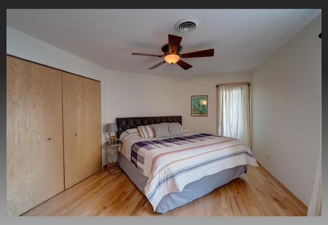 bedroom featuring a closet, ceiling fan, and light wood-type flooring