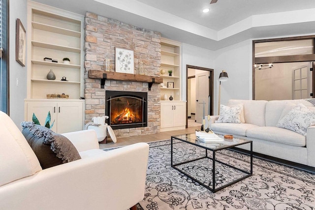 living room with a fireplace and built in features