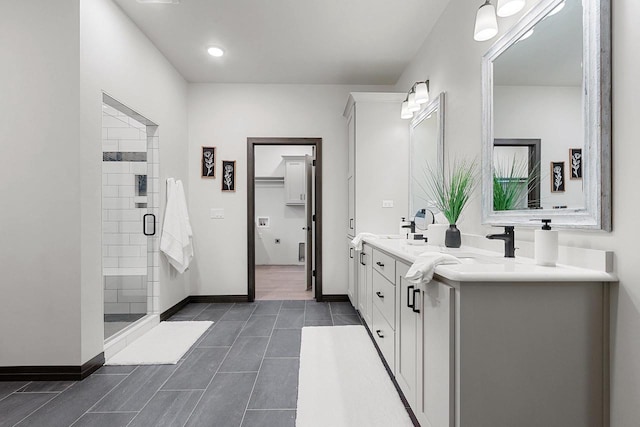 bathroom with vanity and tiled shower