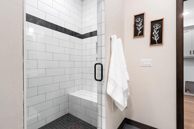 bathroom featuring a shower with door