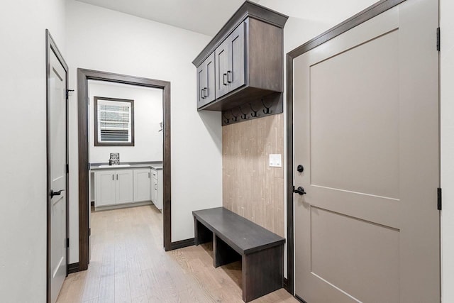 mudroom with sink and light wood-type flooring