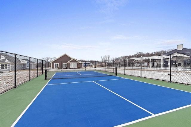 view of tennis court with basketball hoop