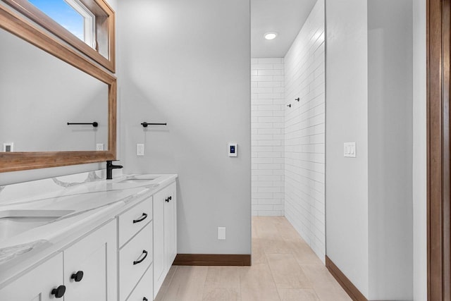 bathroom with vanity and a shower