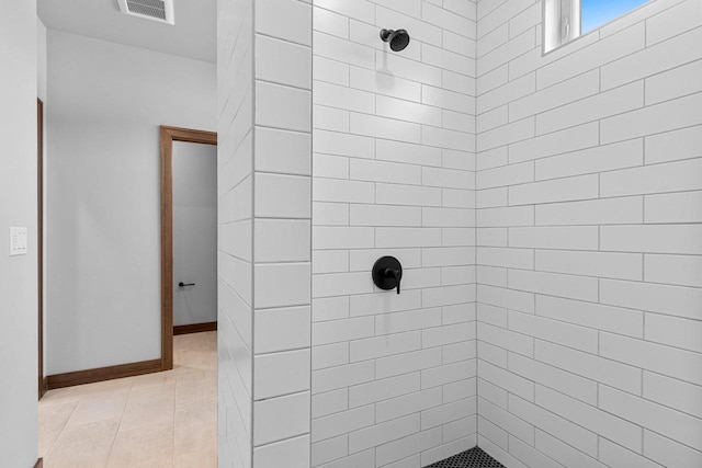 bathroom with a tile shower