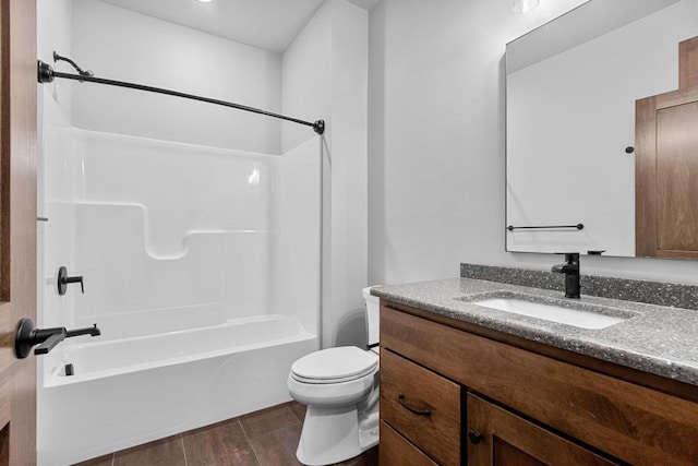 full bathroom with hardwood / wood-style floors, vanity, toilet, and tub / shower combination