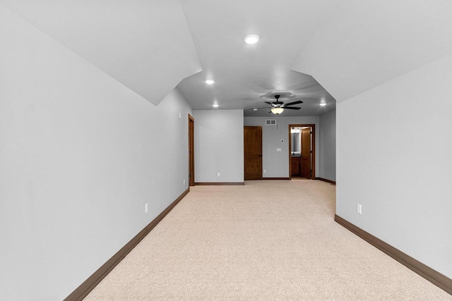 bonus room with ceiling fan and light colored carpet