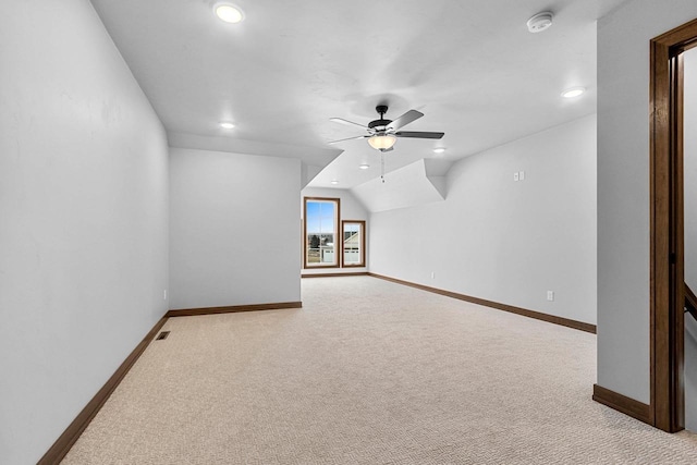 bonus room with light carpet, vaulted ceiling, and ceiling fan