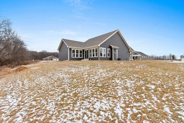 view of snow covered rear of property