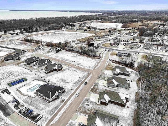 snowy aerial view featuring a water view