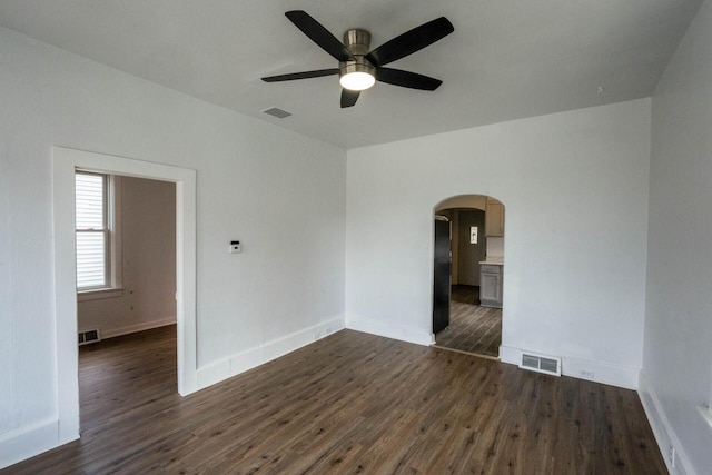 empty room with dark hardwood / wood-style floors and ceiling fan