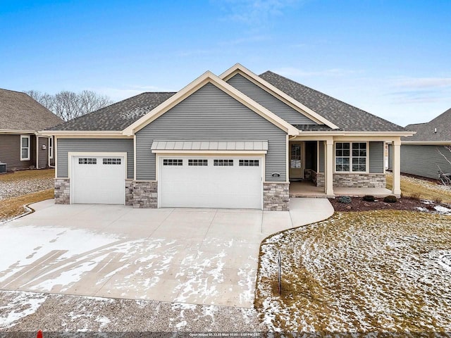 craftsman-style house featuring a porch and a garage