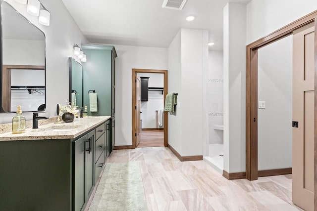 bathroom with a shower and vanity