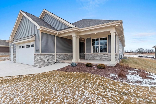 craftsman-style house featuring a porch and a garage