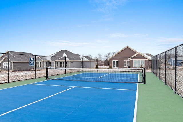 view of tennis court featuring basketball hoop