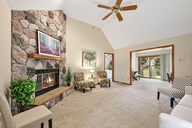 living room featuring ceiling fan, lofted ceiling, a fireplace, and carpet floors