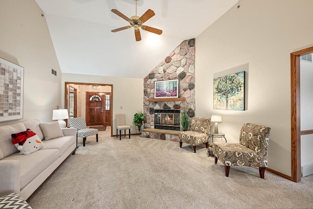 carpeted living room with a stone fireplace, ceiling fan, and high vaulted ceiling