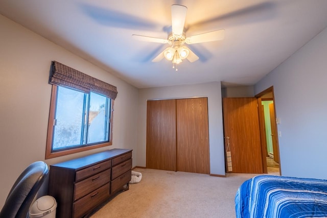 carpeted bedroom featuring ceiling fan and a closet