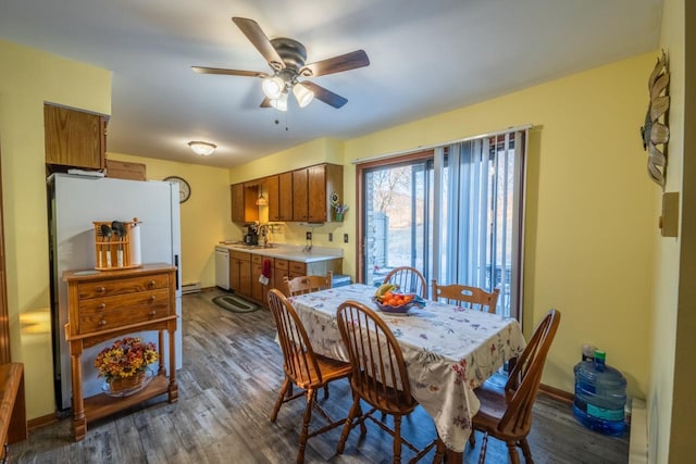 dining space with ceiling fan and dark hardwood / wood-style flooring