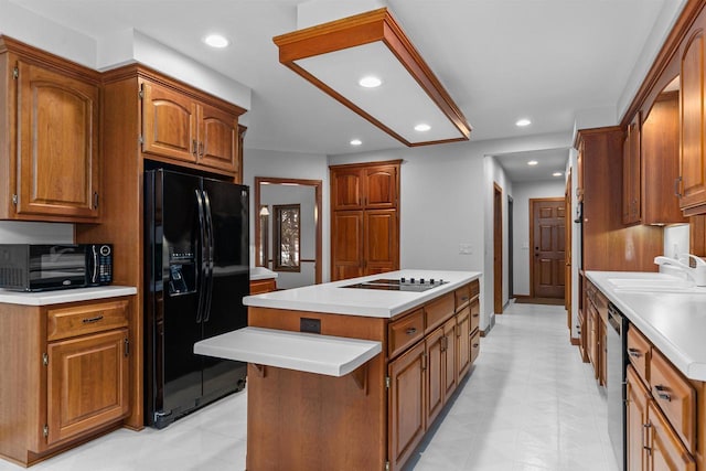 kitchen with sink, stainless steel dishwasher, black fridge with ice dispenser, a kitchen island, and electric stovetop