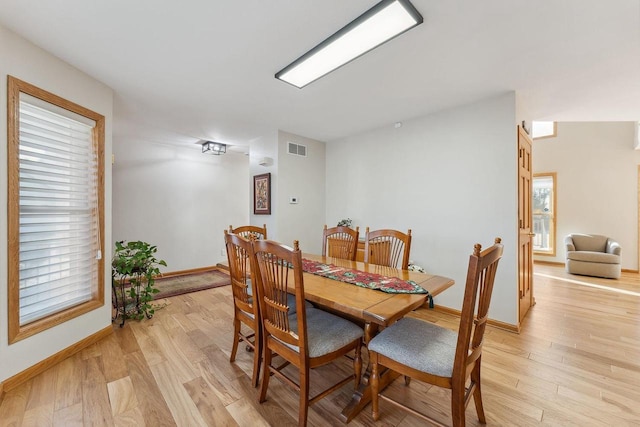 dining room with a healthy amount of sunlight and light hardwood / wood-style floors