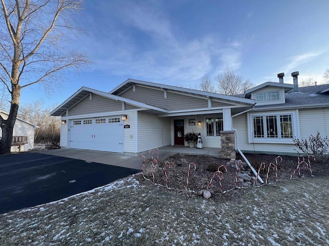 view of front of property with a porch and a garage