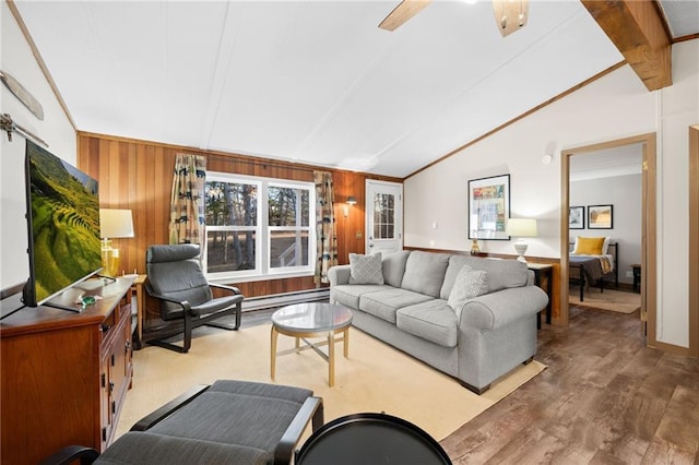 living room with hardwood / wood-style flooring, lofted ceiling with beams, ornamental molding, and wooden walls