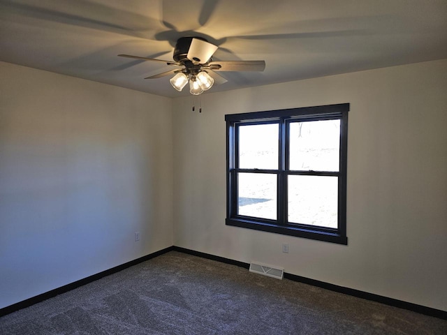 carpeted spare room with ceiling fan