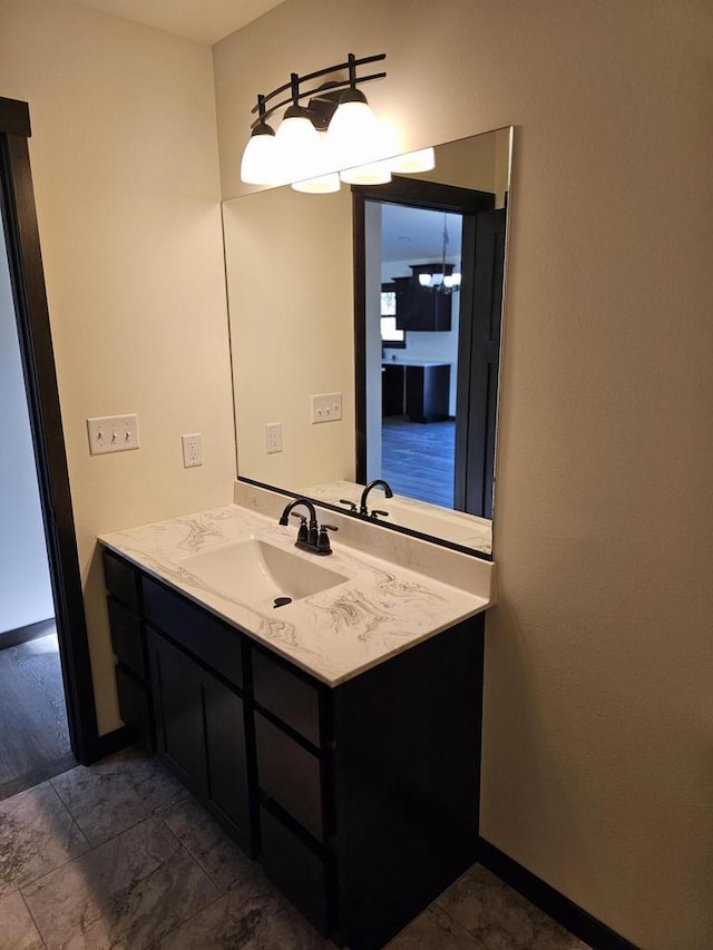 bathroom featuring vanity and a notable chandelier