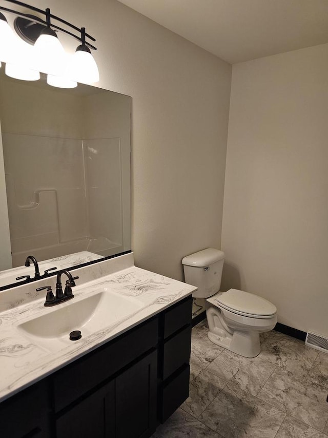 bathroom with vanity, toilet, and walk in shower