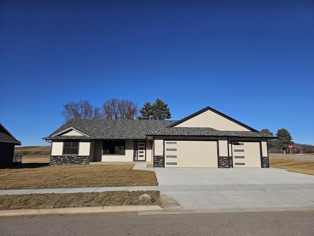 view of front of house with a front lawn and a garage