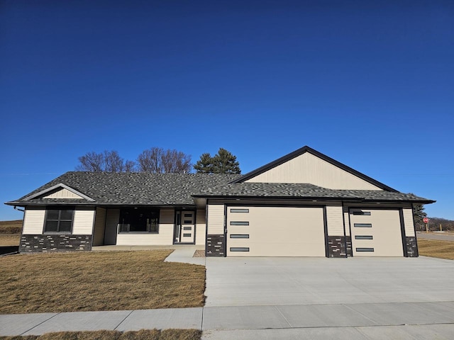 view of front of home with a garage and a front lawn